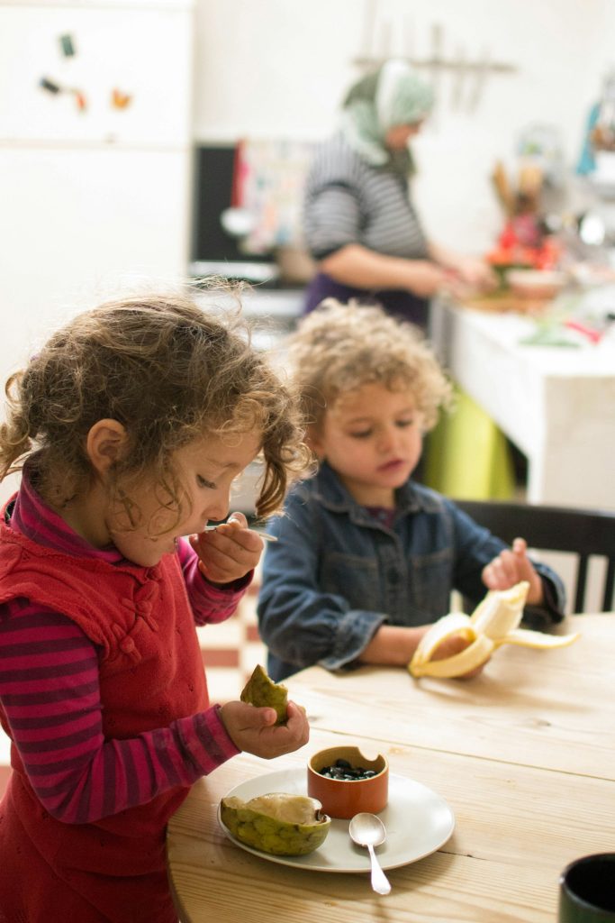Two young children eating together