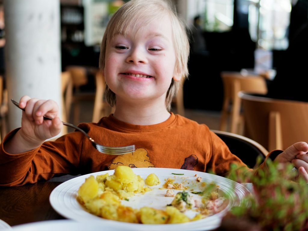 Smiling boy with a healthy plate of food