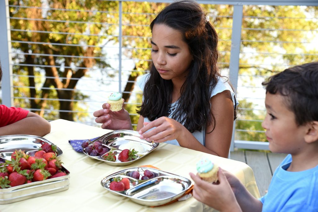 Children enjoying a hot lunch together at school
